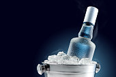 Bottle of cold vodka in bucket of ice