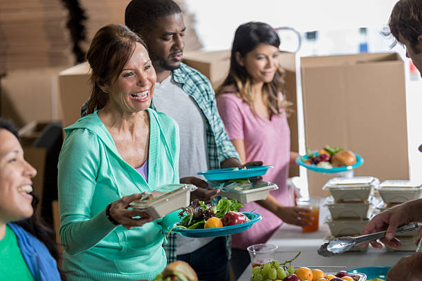 istock Soup kitchen volunteers serve packaged meals in soup kitchen 624441656