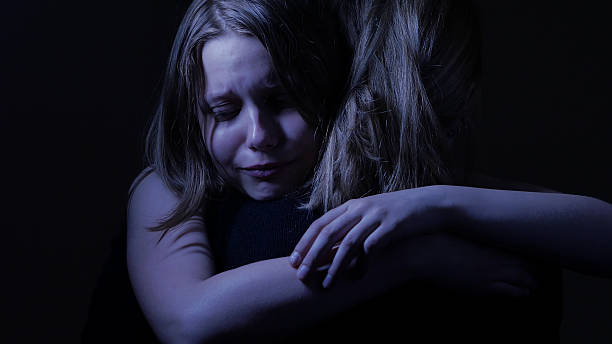 Sad teenager daughet and her loving mother. stock photo