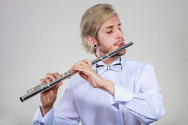 istock Male flutist playing his flute 624445148
