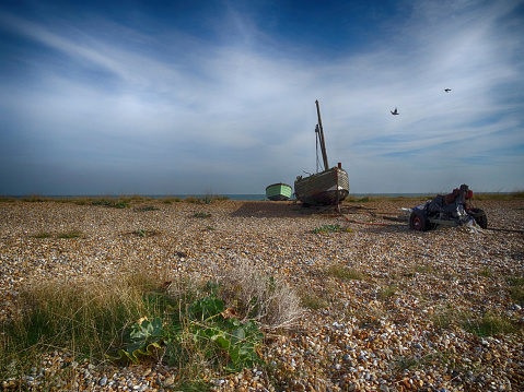 Old decaying boats on the beach at Greatstone near Dungeness in Kent