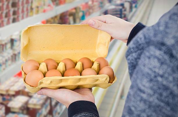 istock Man holding egg box in supermarket 624457526