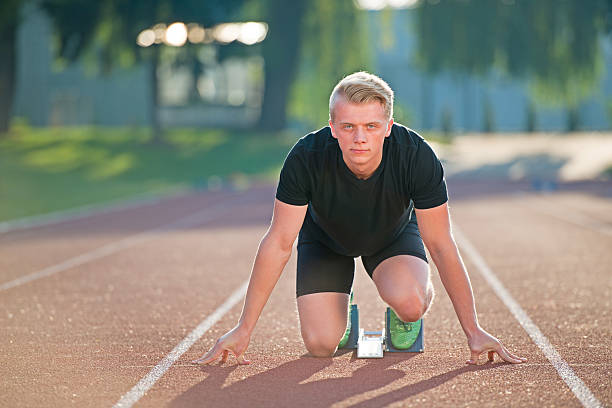 istock Athletic man on track starting to run. 624460028