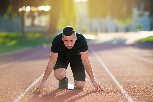 istock Athletic man on track starting to run. 624461214