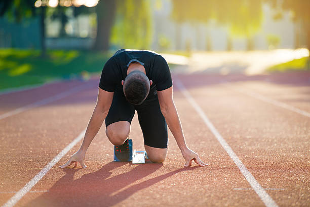 istock Athletic man on track starting to run. 624461354