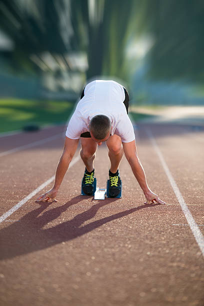 istock Athletic man on track starting to run. 624461658