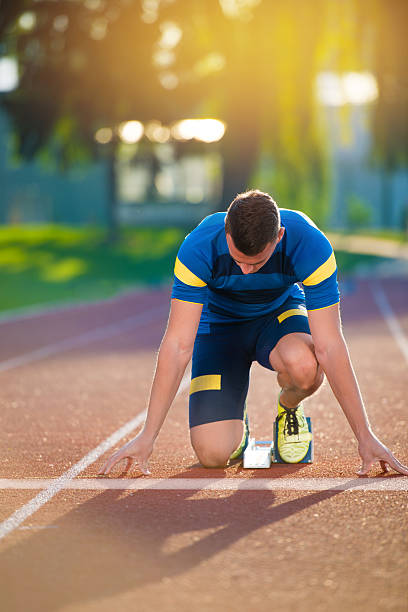 istock Athletic man on track starting to run. 624472088