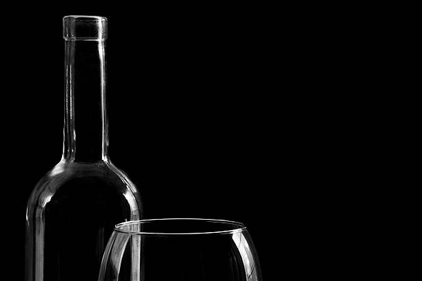 bottle of white wine isolated on yellow background, golden cap