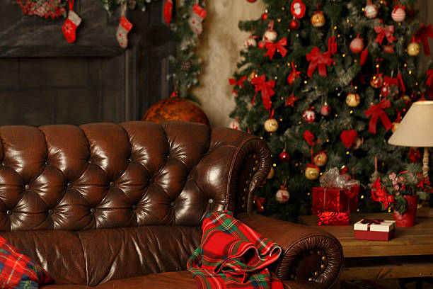 Atmospheric Christmas background with a warm blanket and a Christmas tree. Homeliness.
