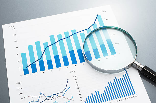 istock Reviewing business report. Looking at growth chart with magnifyi 624475374