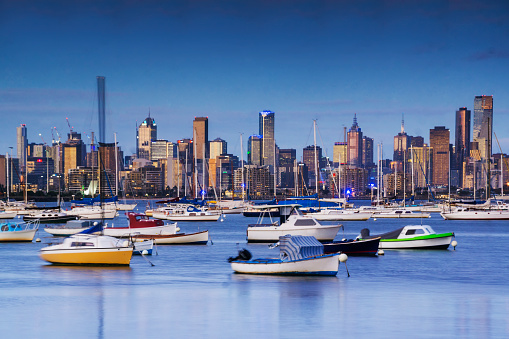 Melbourne's skyline from Williamstown foreshore, with various boats in the foreground.