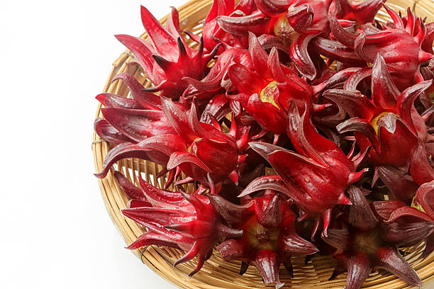 istock Roselle fruits in bamboo basket, isolated on white 624476384