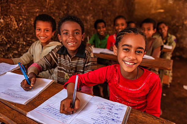 African children during the class, East Africa African children during Amharic language class in very remote school. The bricks that make up the walls of the school are made of clay and straw. There is no light and electricity inside the classroom africa school stock pictures, royalty-free photos & images