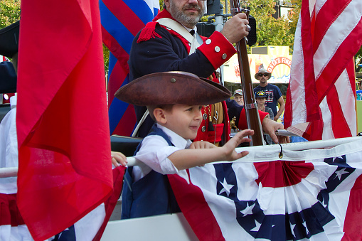 Sacramento, California USA - November 11, 2016: Young boy rides on float in the Sacramento Veterans Day Parade