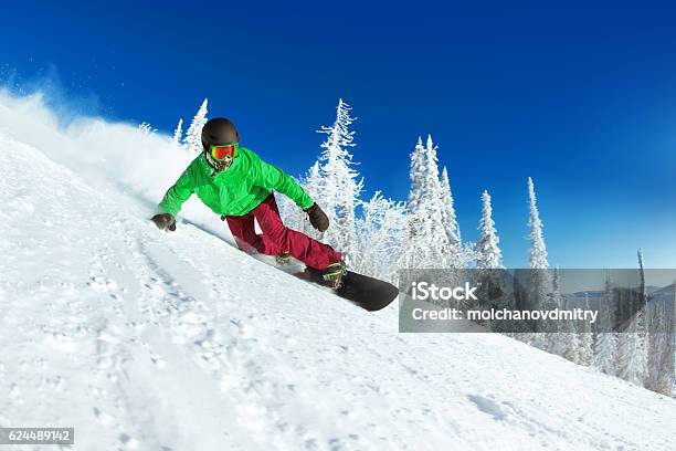 Active Snowboarder Snowboarding Rides Closeup Stock Photo - Download Image Now - Snowboarding, Snowboard, Sliding
