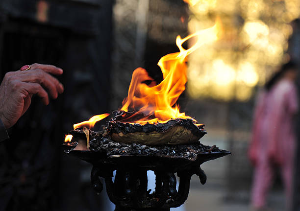 Burning fire offerings at Buddhist shrine Kathmandu Nepal