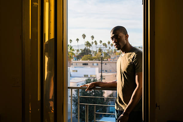 istock Young black man standing on open balcony, Santa Monica, California 624490938