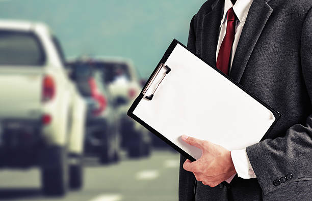 istock business man hold car report 624491130