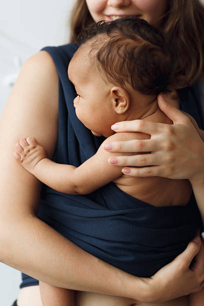 Mother holding her baby in sling