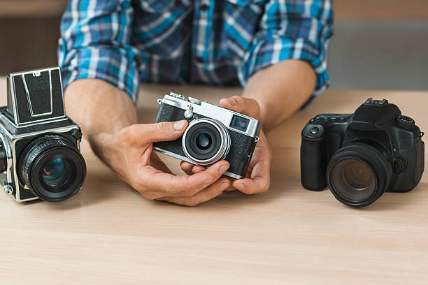 istock Unrecognizable man shows simple film camera 624493306