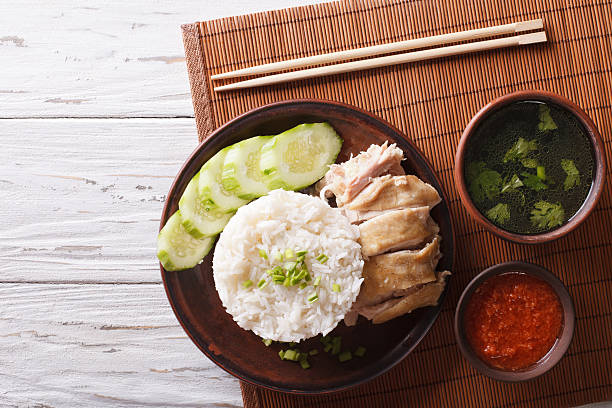 Hainanese chicken rice, chilli sauce and bouillon. Horizontal