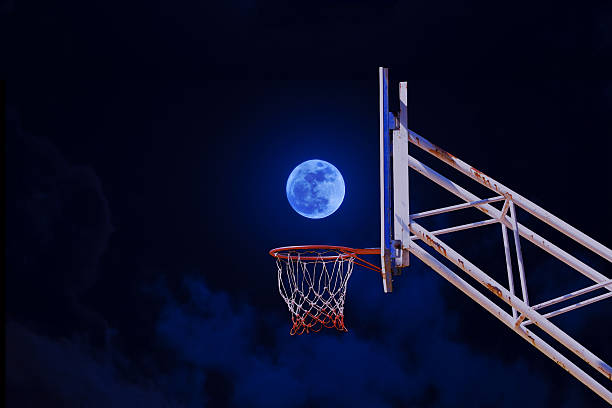 moon in a basketball hoop. stock photo
