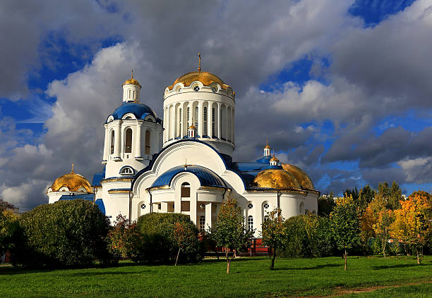 Golden domes of the Orthodox church in the background of the cloudy autumn sky