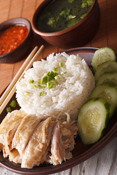 istock Hainanese chicken rice with cucumber close-up and broth. vertical 624495444