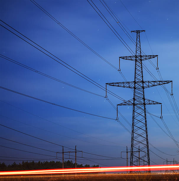 istock Electrical pylon and high voltage power lines at night. 624496752