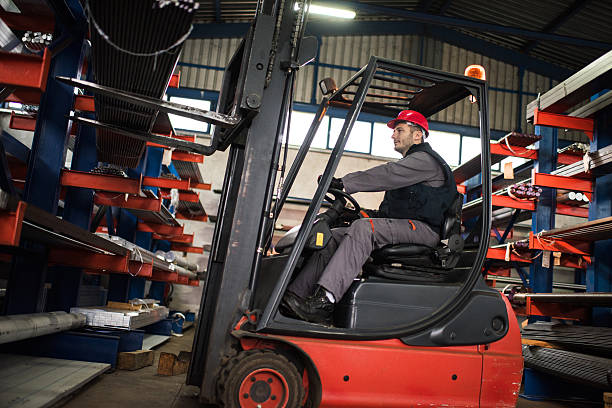 istock Mid adult worker driving a forklift in aluminum mill. 624497182