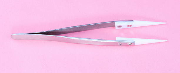 istock Steel Ceramic Tweezer  on pink background 624497592