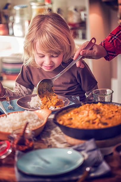 istock Eating Delicous Homemade Chicken Curry Dish with Rice 624497992