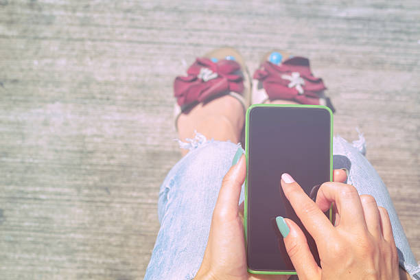 istock Girl texting while sitting on the bench outdoors. 624499012