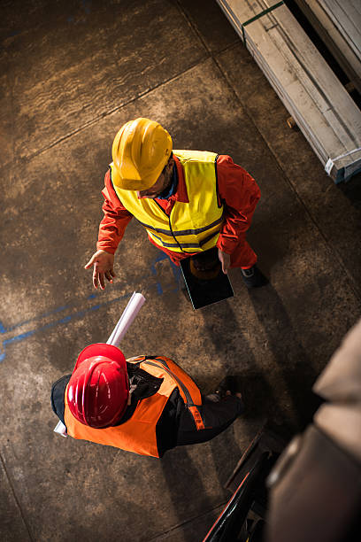 istock Above view of metal workers talking to each other. 624510588