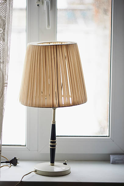 istock Old lamp with shade on an  window in a village 624510684