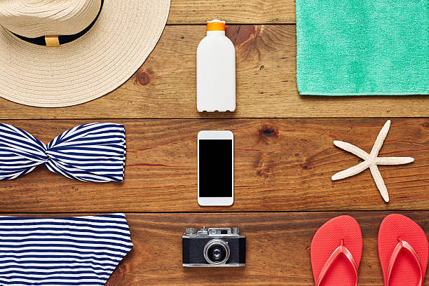istock Flat lay of smart phone surrounded with beach accessories 624512124