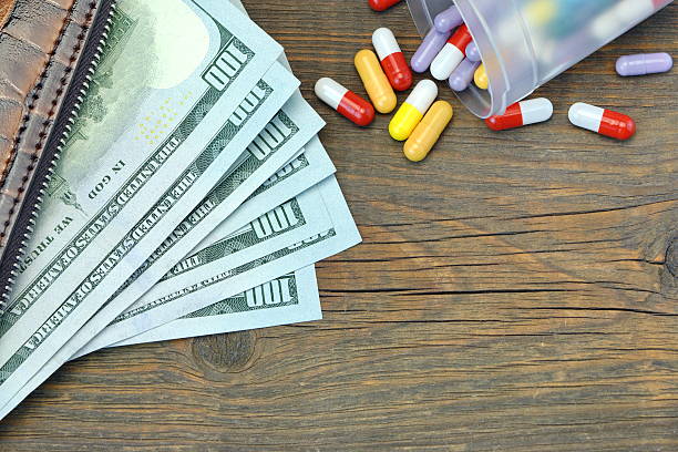 istock Wallet With US Dollar Cash And Medication On Wood Background 624512864