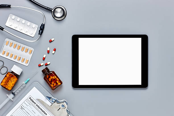 istock Digital tablet with medical equipment on gray background 624513772