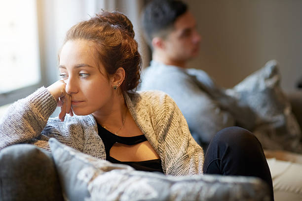 Going through a rough patch Shot of a young woman looking despondent after a fight with her boyfriend relationship difficulties stock pictures, royalty-free photos & images