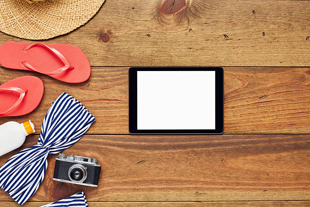 istock Flat lay of digital tablet by beach accessories on wood 624532622