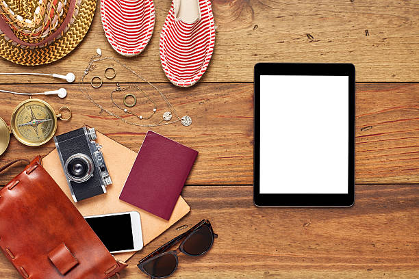 istock Digital tablet by beach accessories flat lay on wooden floor 624532820
