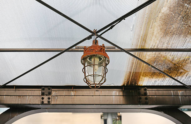 old, abandoned factory. Scattered glass, iron, wooden remains of  production on  floor, covered with snow and sawdust. Broken pipes, broken wiring, signal lights, broken roof and crane girder.