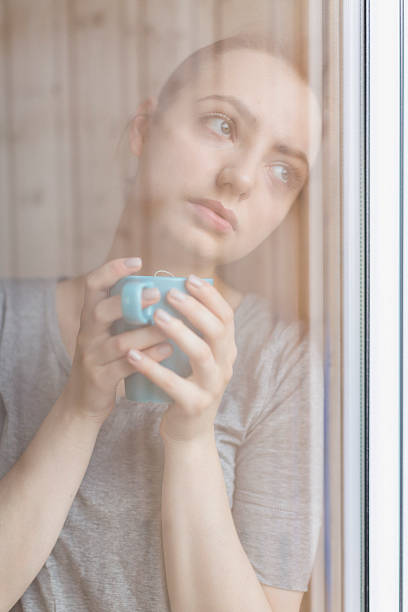 istock Woman looking out the window 624533298