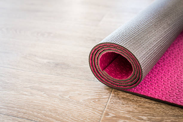 istock Yoga mat on a wooden background. 624540220