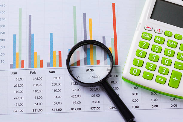 istock Calculator and magnifying glass on the table 624540750