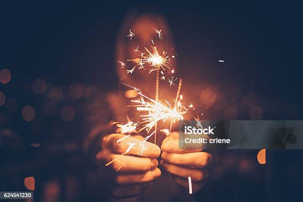 Man Holding Sparklers In His Hands Stock Photo - Download Image Now - New Year's Eve, Party - Social Event, Firework Display