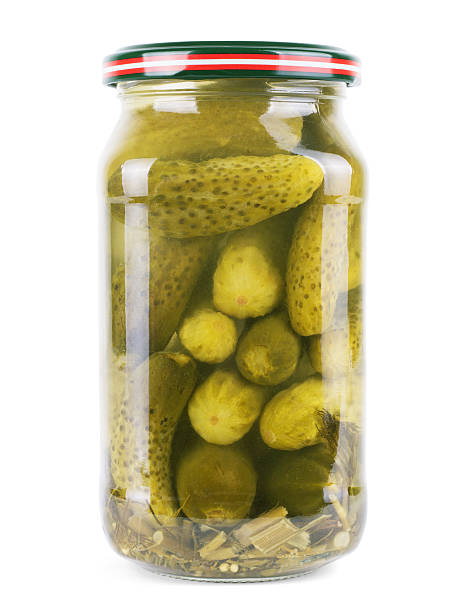 istock Pickled cucumbers in a glass jar isolated on white background 624541266