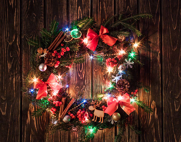 istock Christmas wreath on wood board 624541330