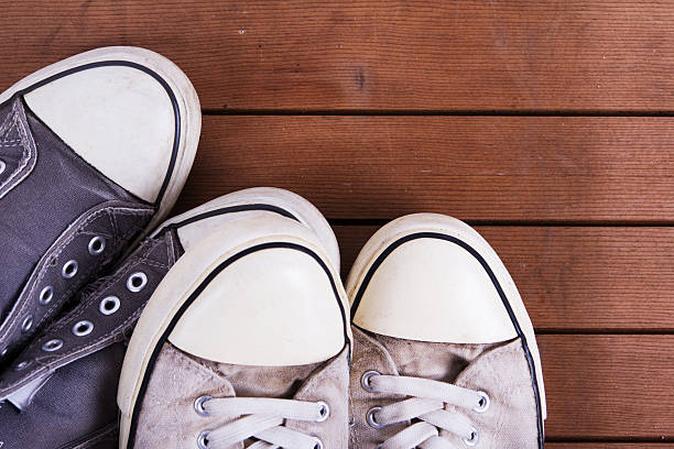 istock Old canvas shoes on a wooden floor 624542972