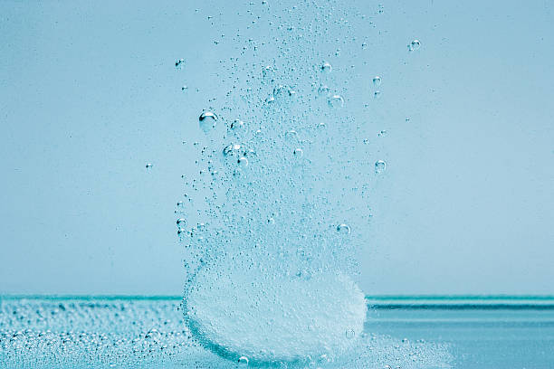 tablet dissolving in water stock photo